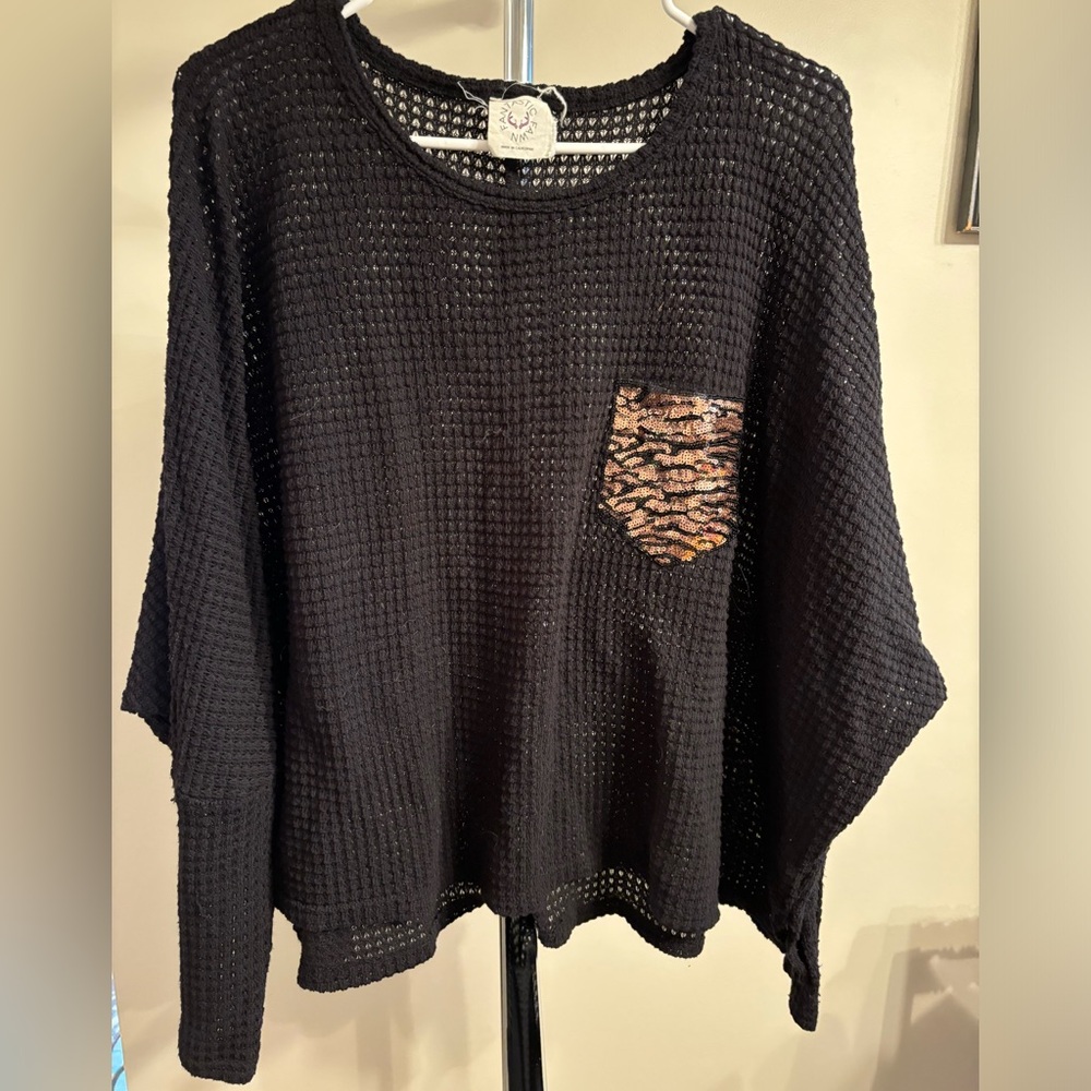 Black sweater with sequin pocket